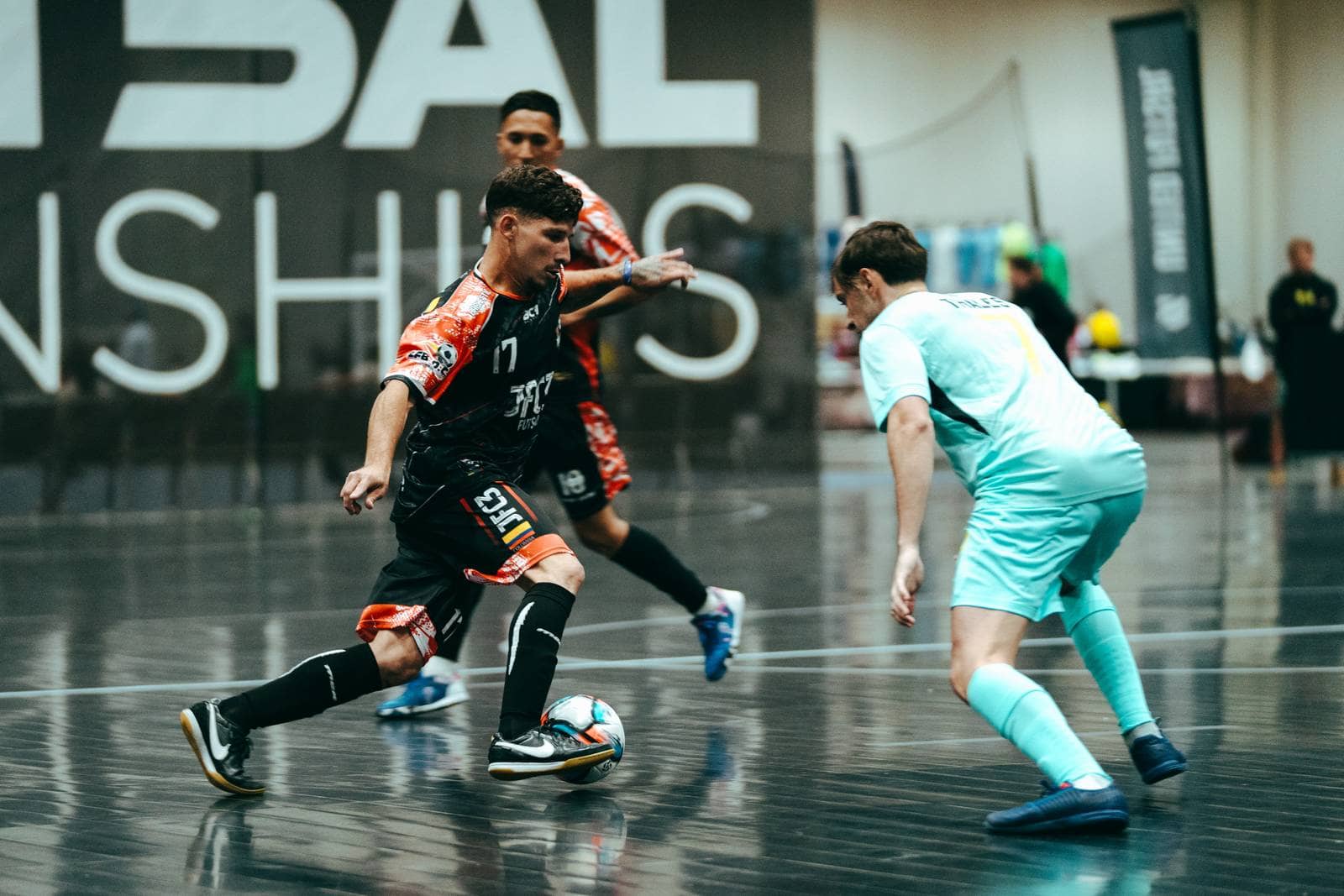 A player runs at a defender with the ball under control