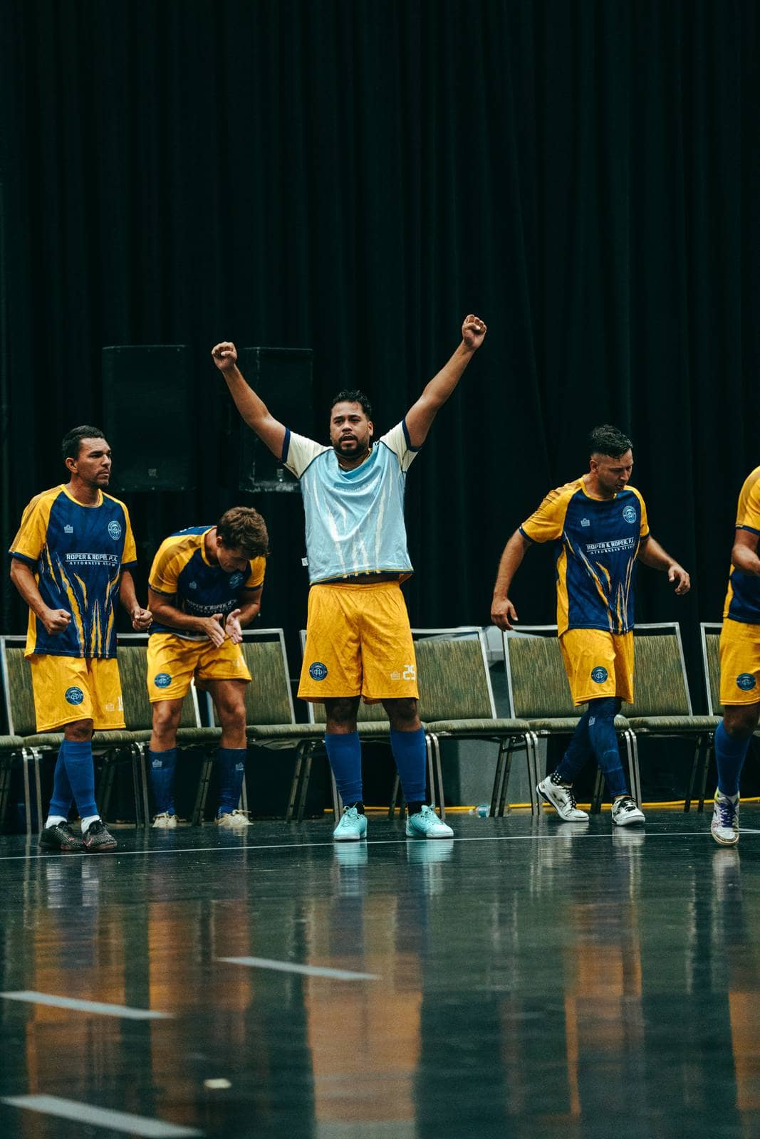 A substitute raises both fists in front of the bench